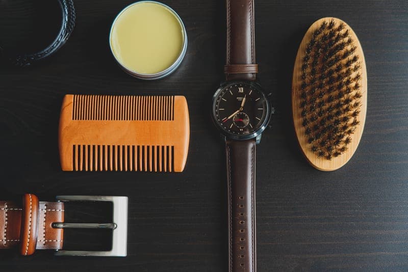 A flat lay of men's grooming and accessory items