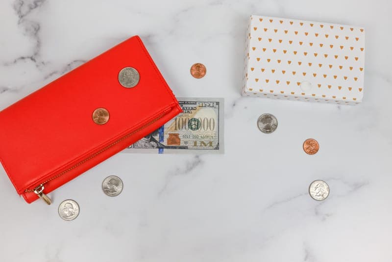 A wallet being handed over as a gift