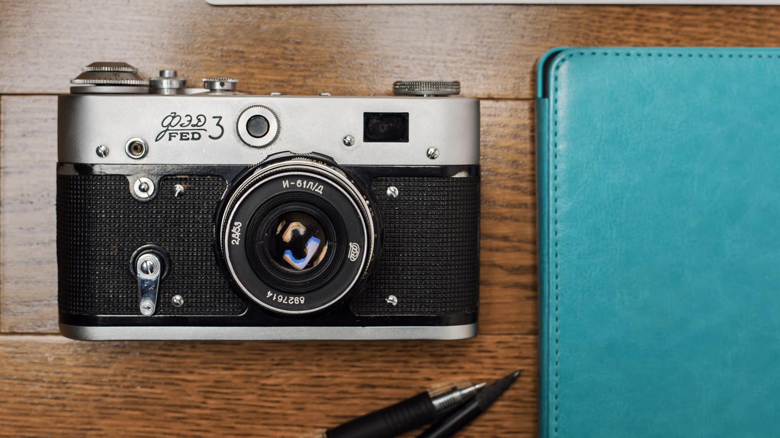 A desk with hobby items including coffee and a camera