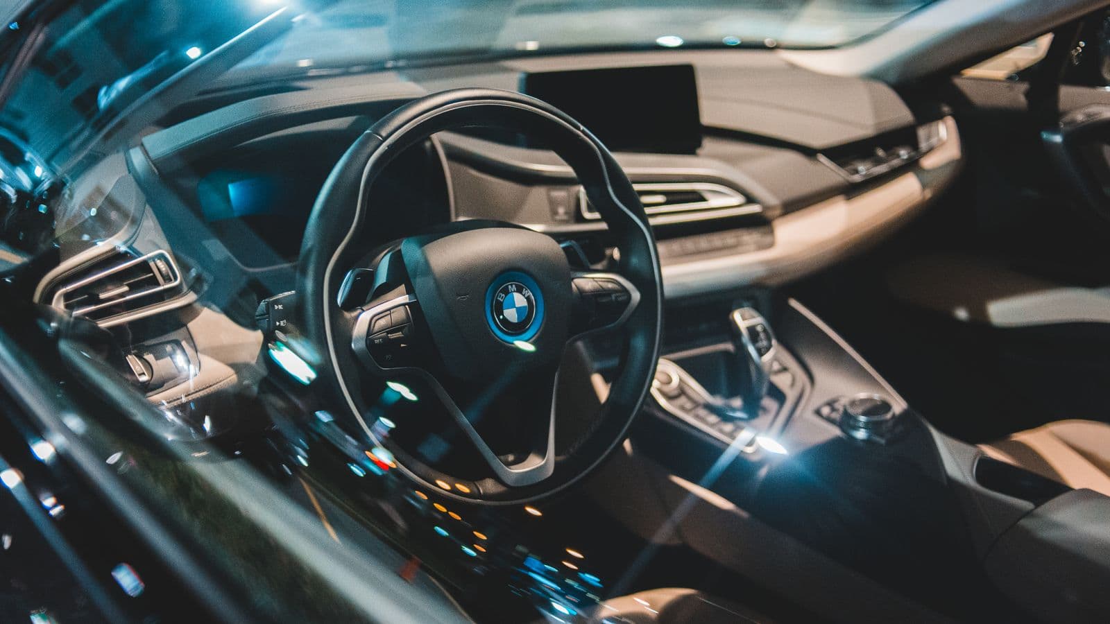 The dashboard and steering wheel of a modern car, seen through the windshield