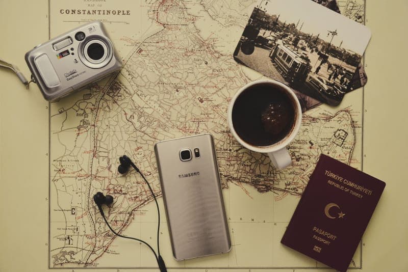 A passport and headphones in a travel flat lay