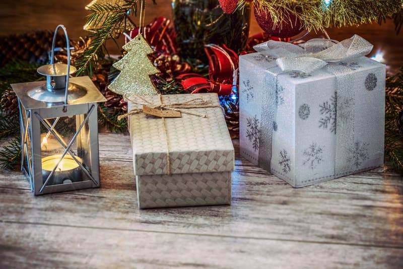 Christmas presents beside tree lights