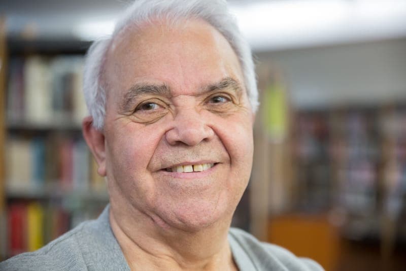A smiling grandfather in a relaxed portrait