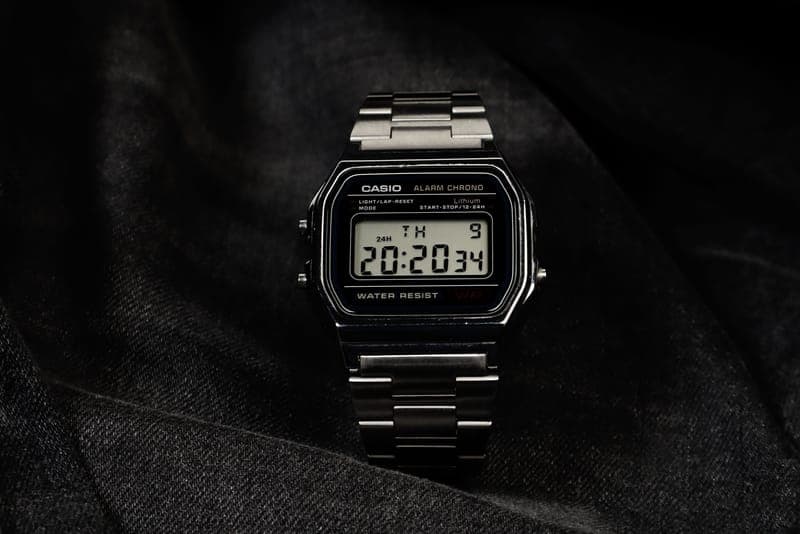 A retro digital wristwatch on a plain background