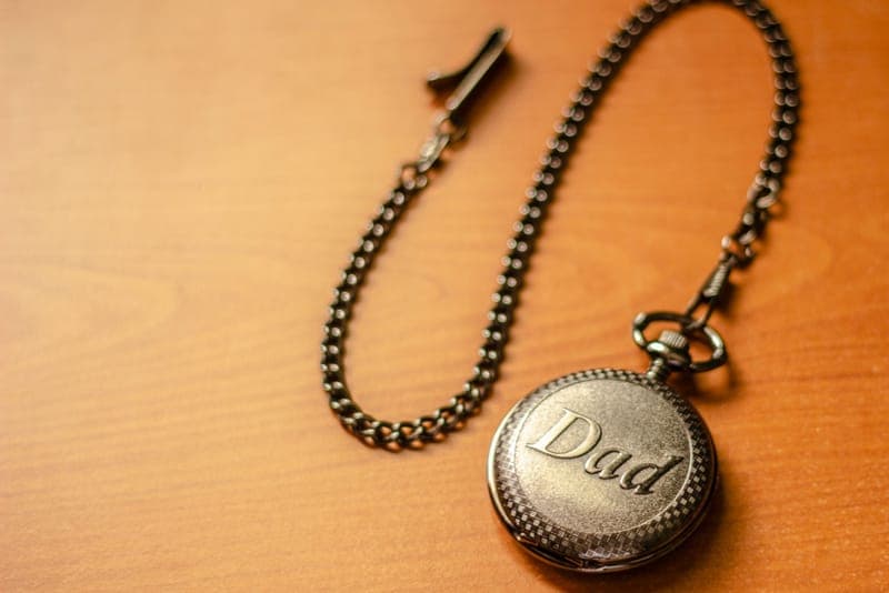 An engraved metal keepsake held in two hands