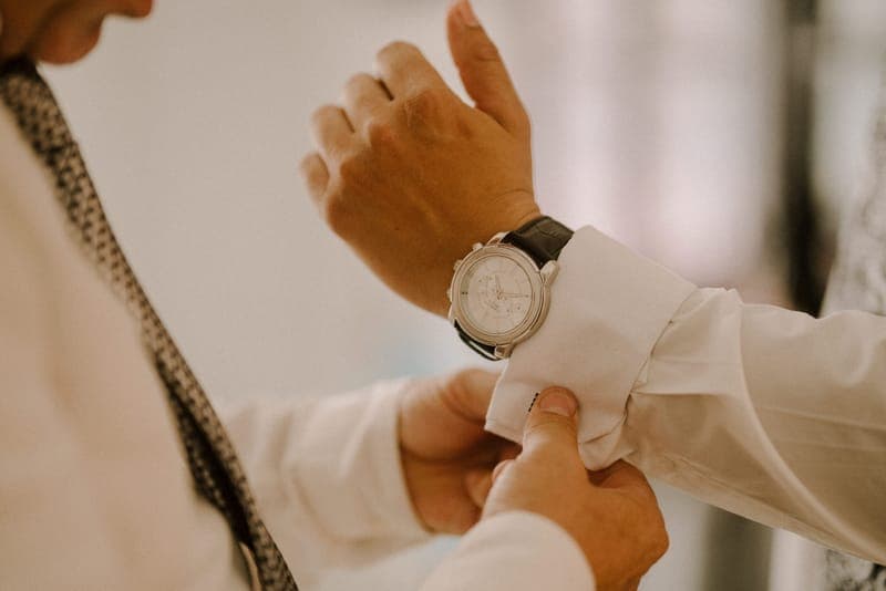 Cufflinks and a watch laid out before a wedding