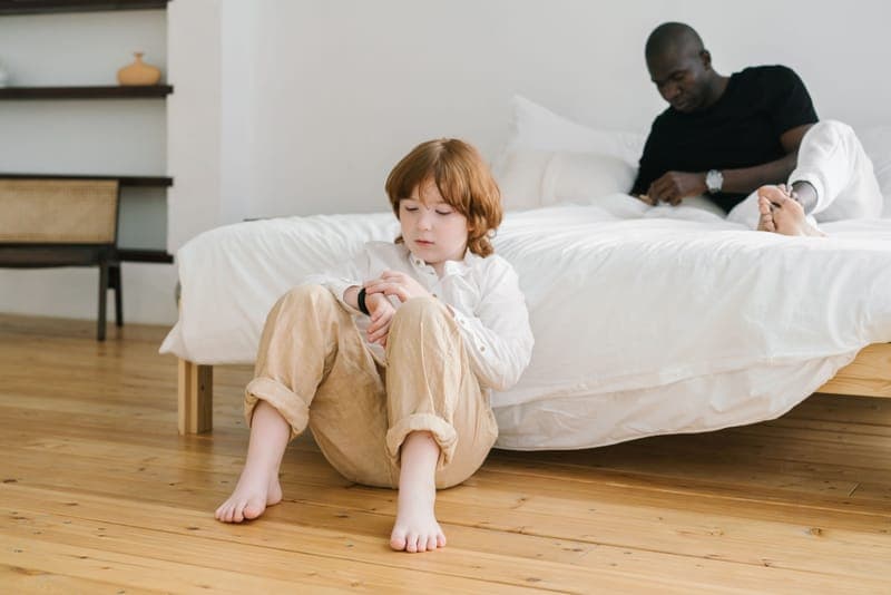 A child looking at the time on a wristwatch