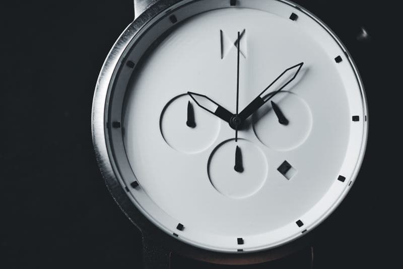 A minimalist watch with a plain white dial